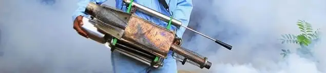 Fumigation technician using a fogger for deep pest treatment in Baltimore, MD